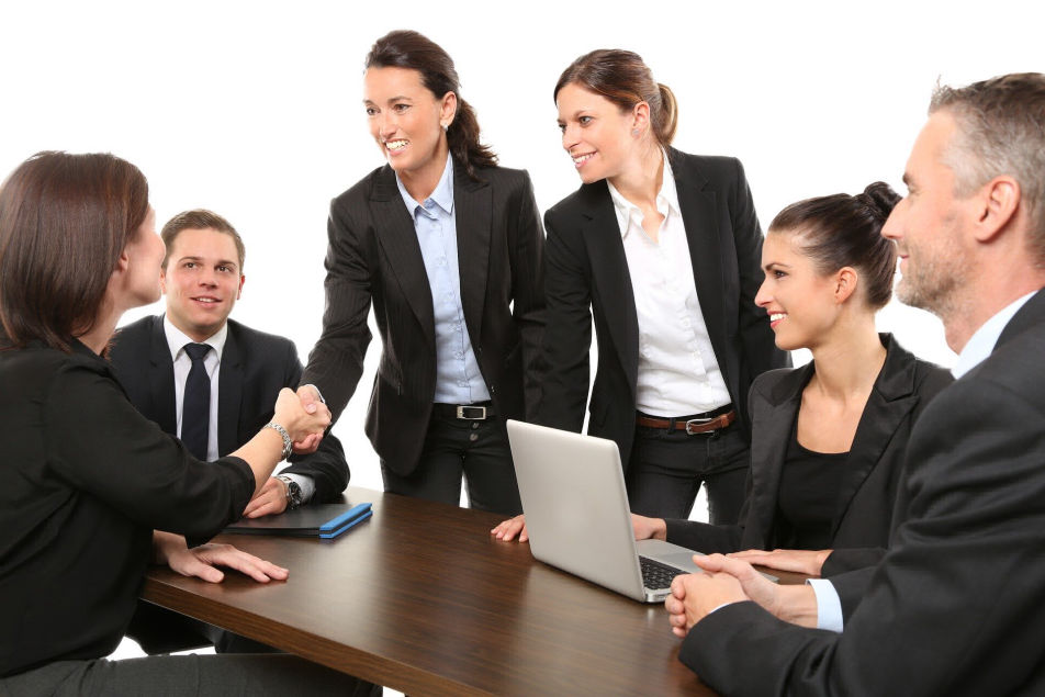 Group of people around a desk collaborating.